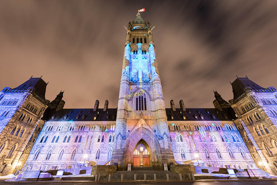Winter holiday light show projected at night on the Canadian House of Parliament to celebrate the 150th Anniversary of Confederation of Canada in Ottawa, Canada.